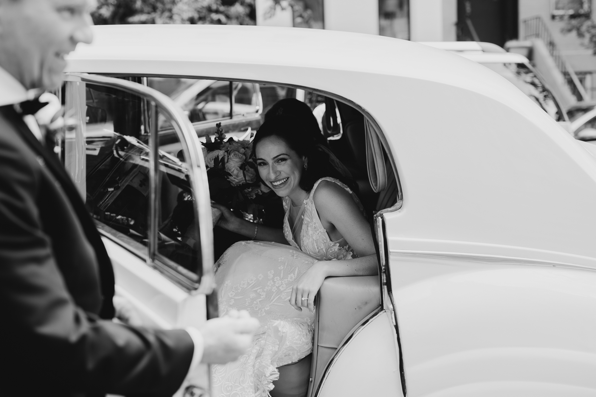 a bride getting out of her wedding car at liberty warehouse in brooklyn, new york city