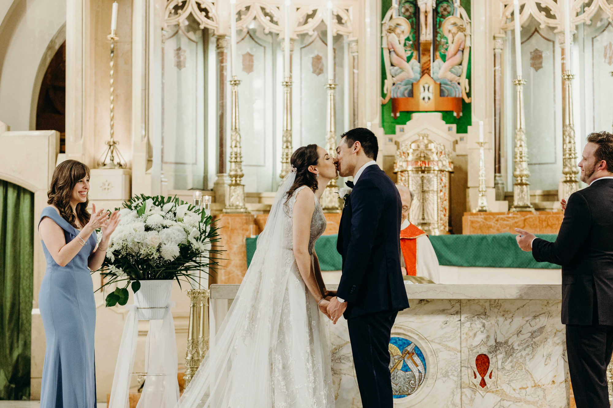 a bride and groom kiss during their wedding ceremony at a church in bay ridge, brookyn