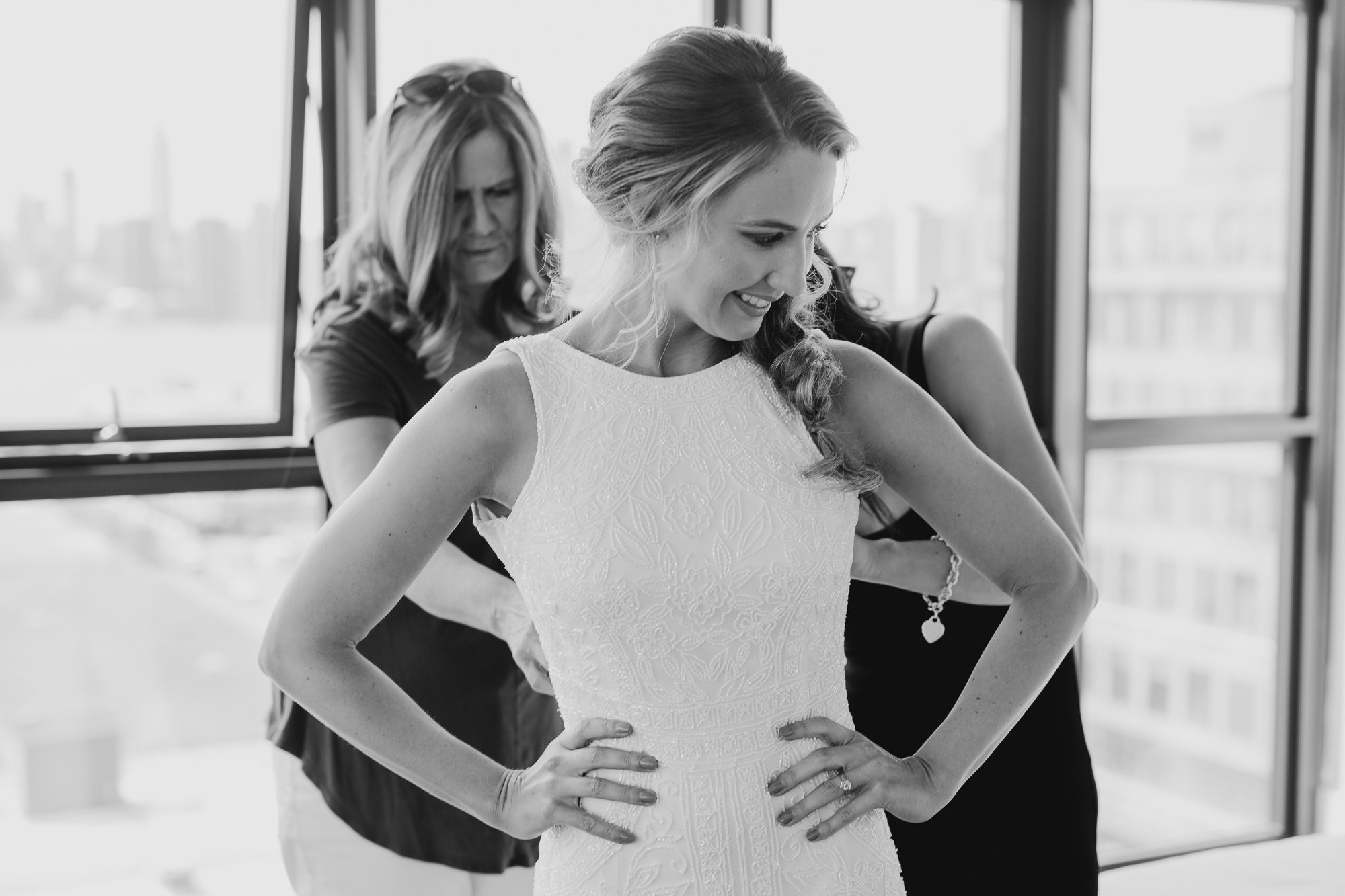 a bride getting into her wedding gown at the wythe hotel in brooklyn, new york city