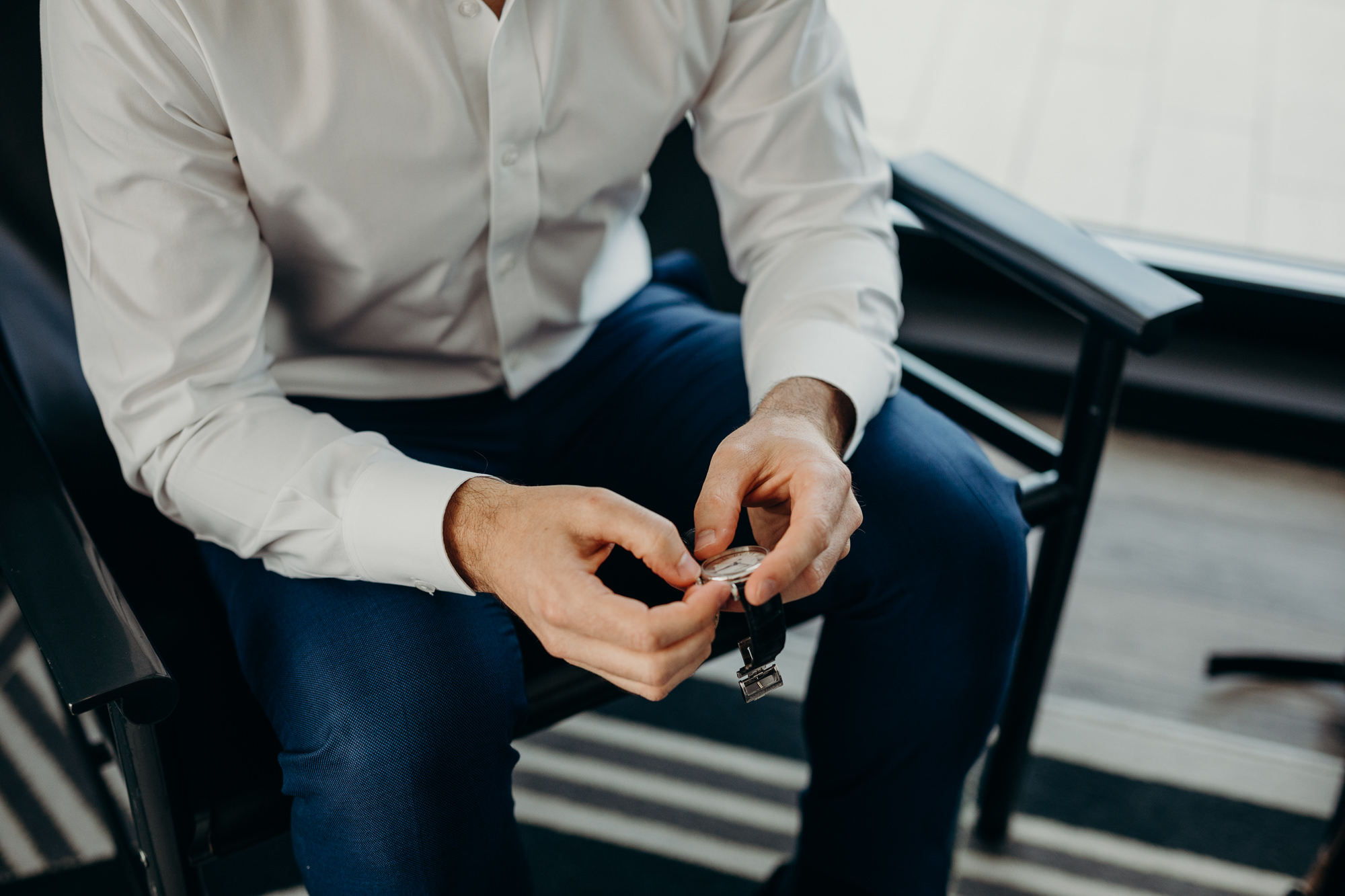 a groom setting his watch at the wythe hotel in brooklyn, new york city