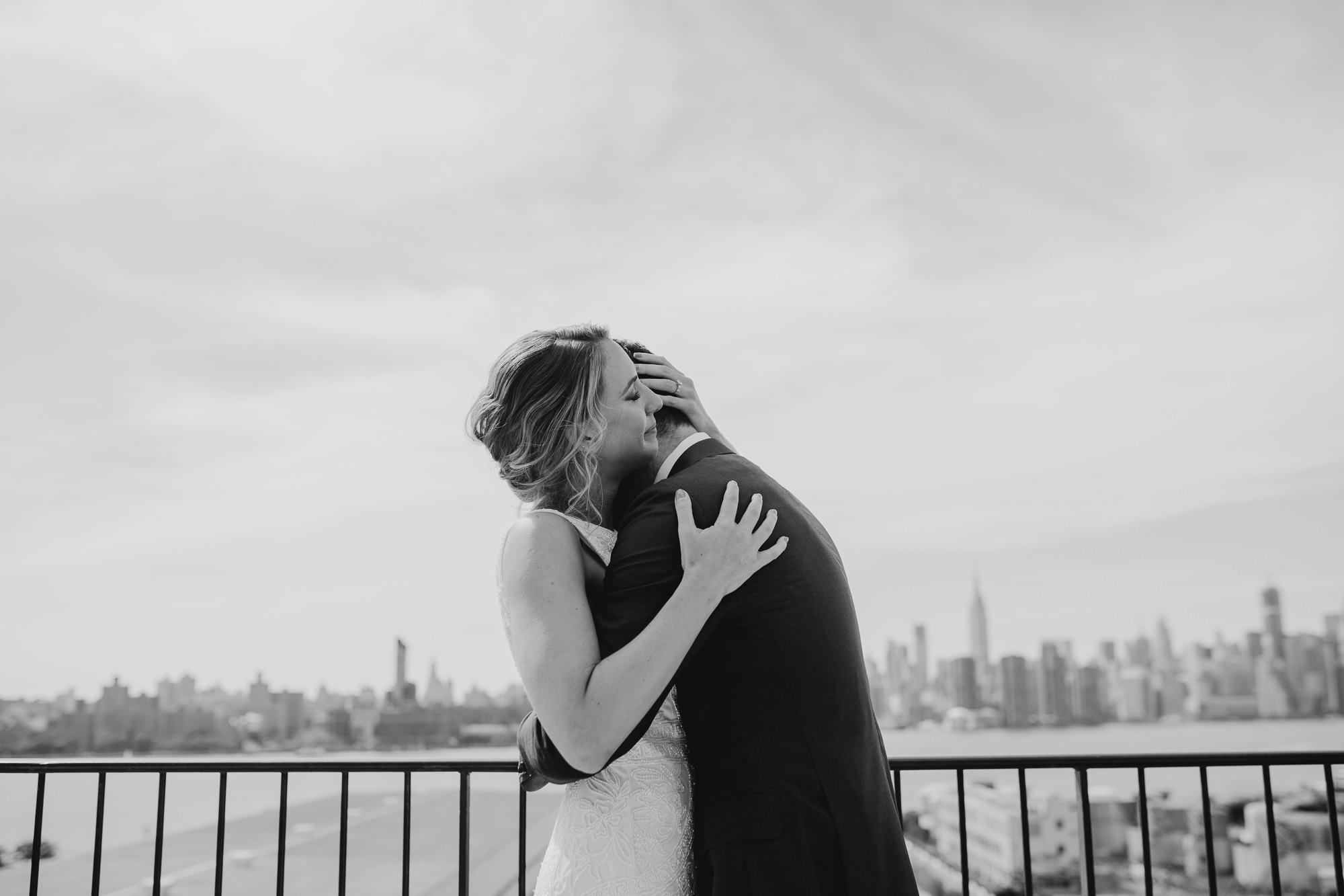 a bride and groom hug on their wedding day at the wythe hotel in brooklyn, new york city