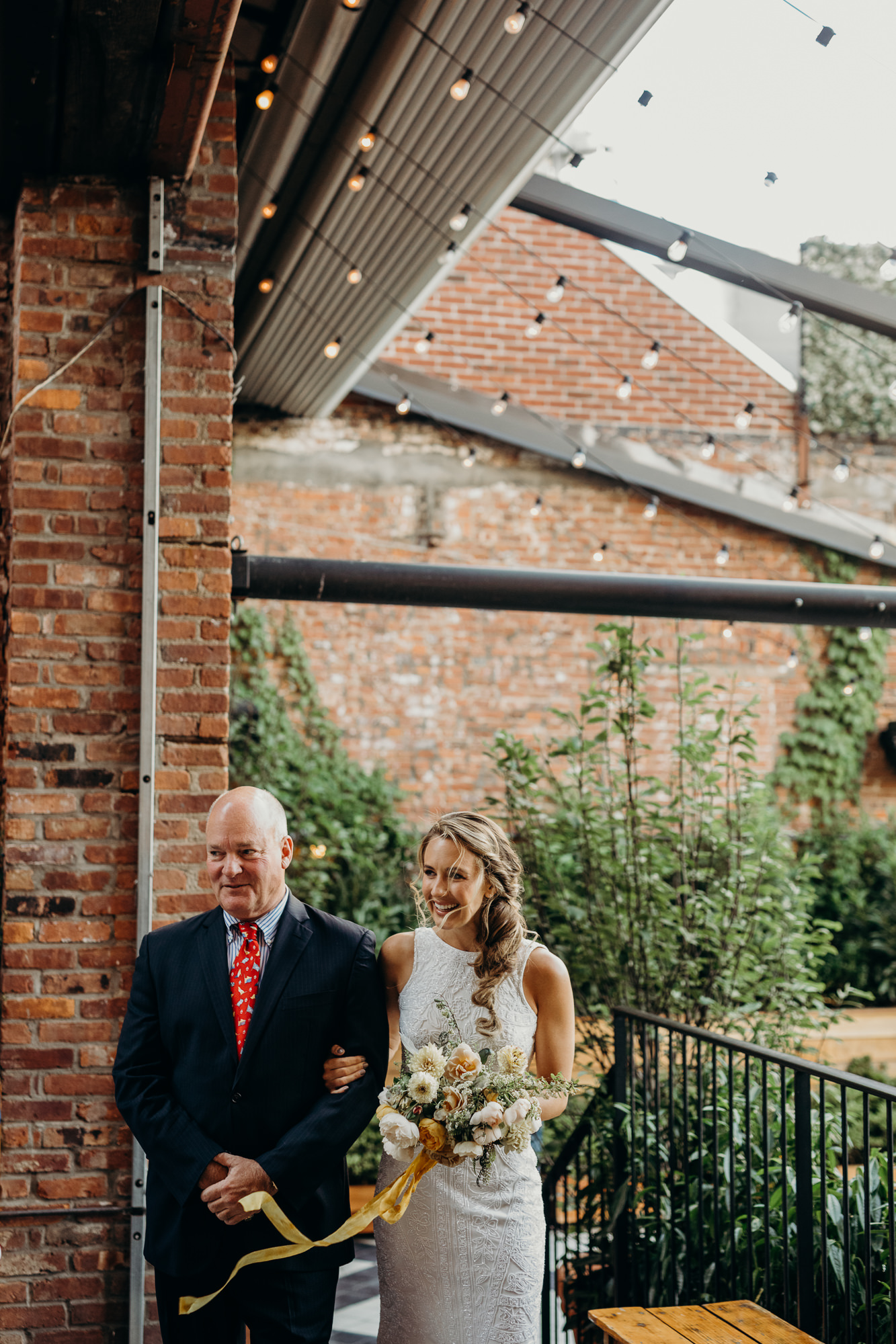 a bride and her father walk down the aisle at the wythe hotel in brooklyn, new york city