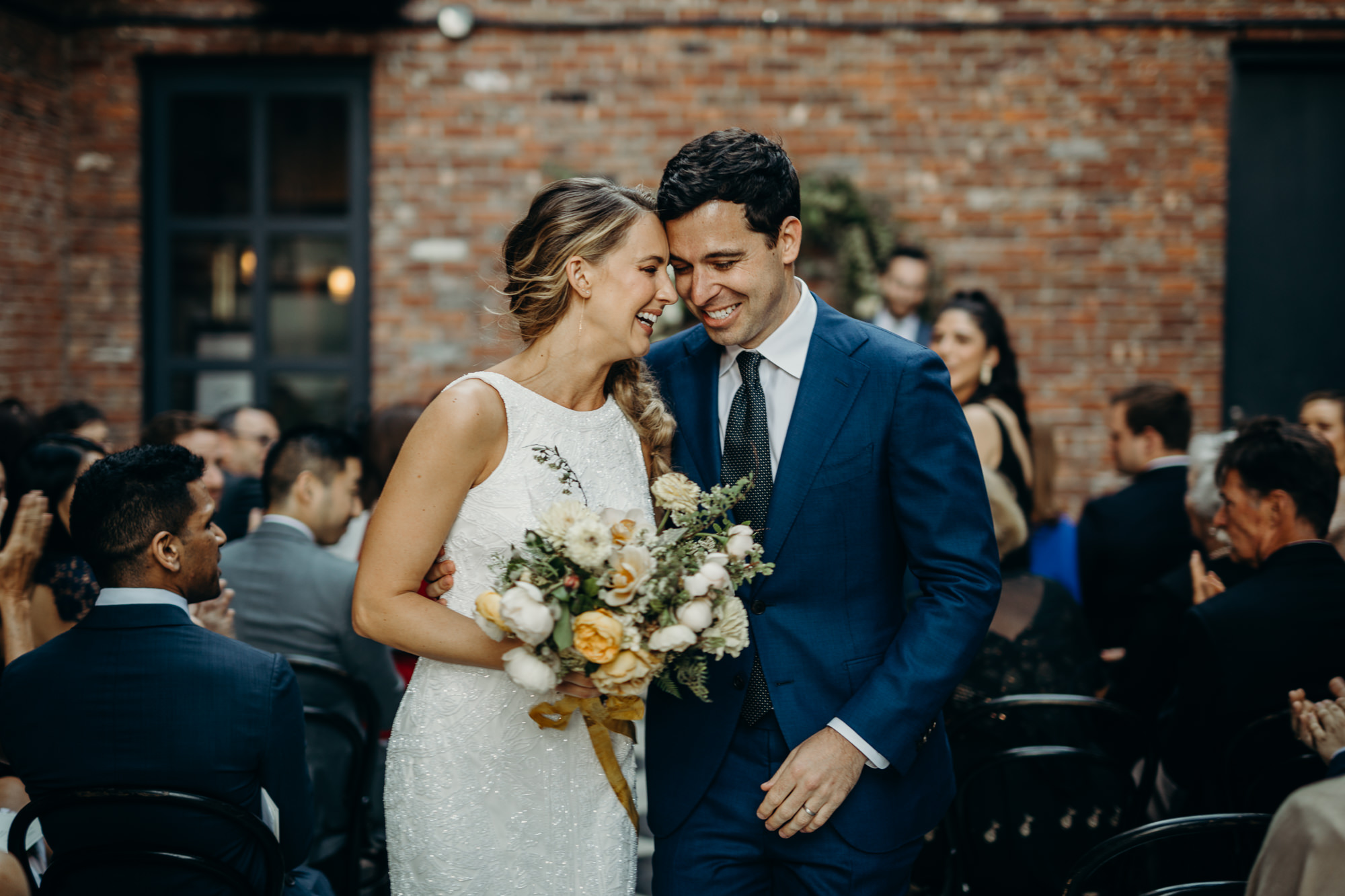 a bride and groom at a wedding ceremony at the wythe hotel in brooklyn, new york city