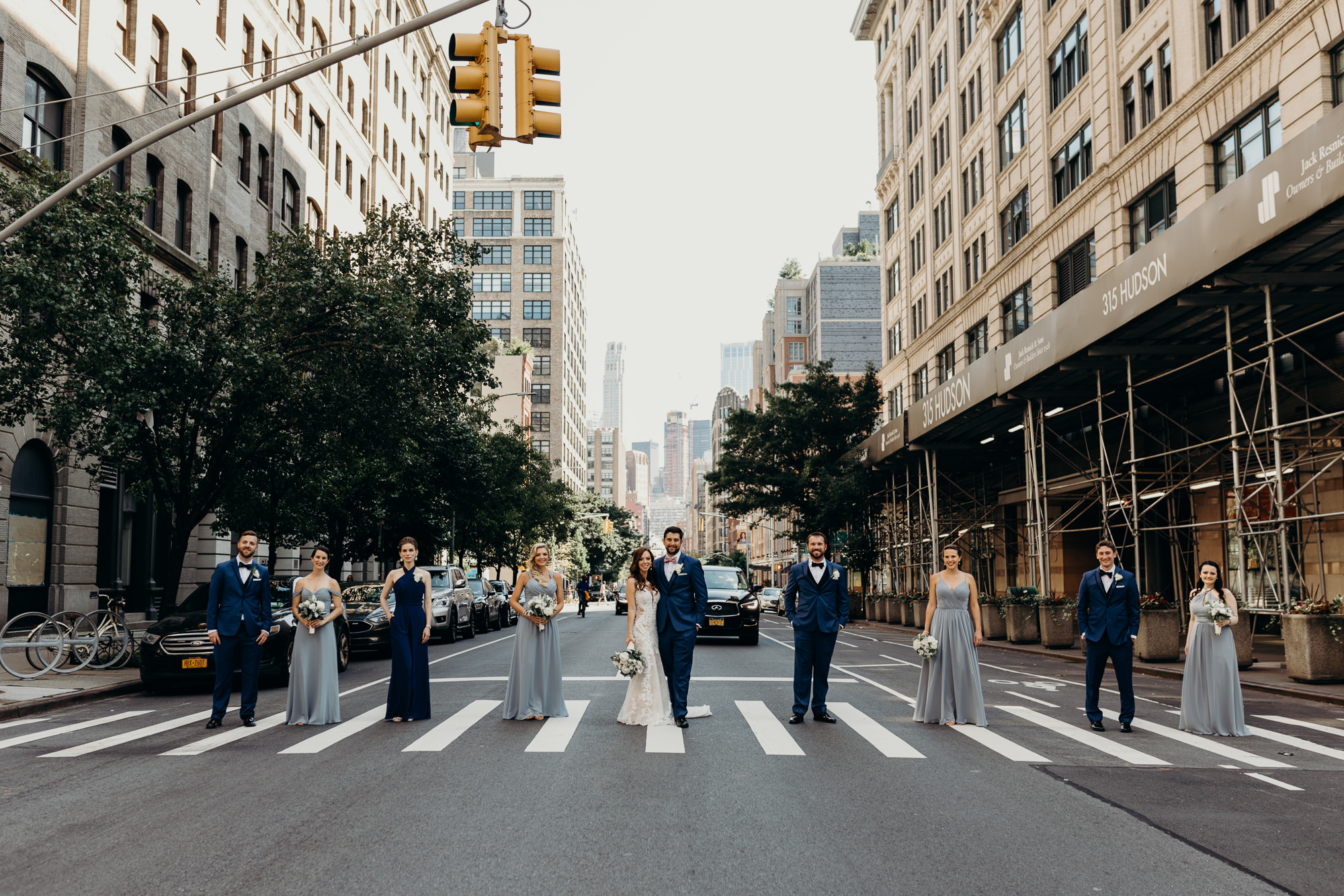 a portrait of a bride and groom with their wedding party at city winery in new york city, new york