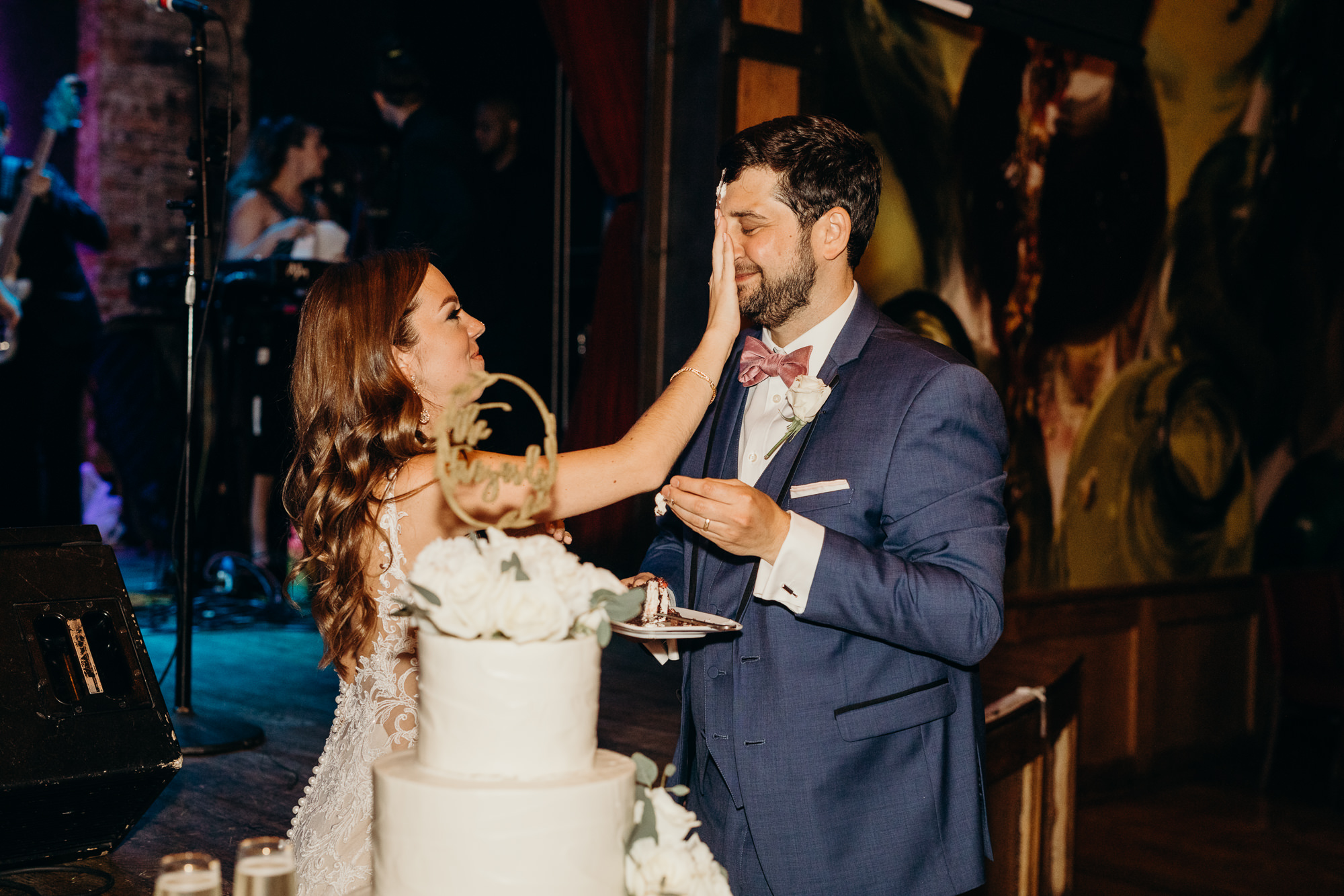 a bride and groom cut their wedding cake at city winery in new york city, new york