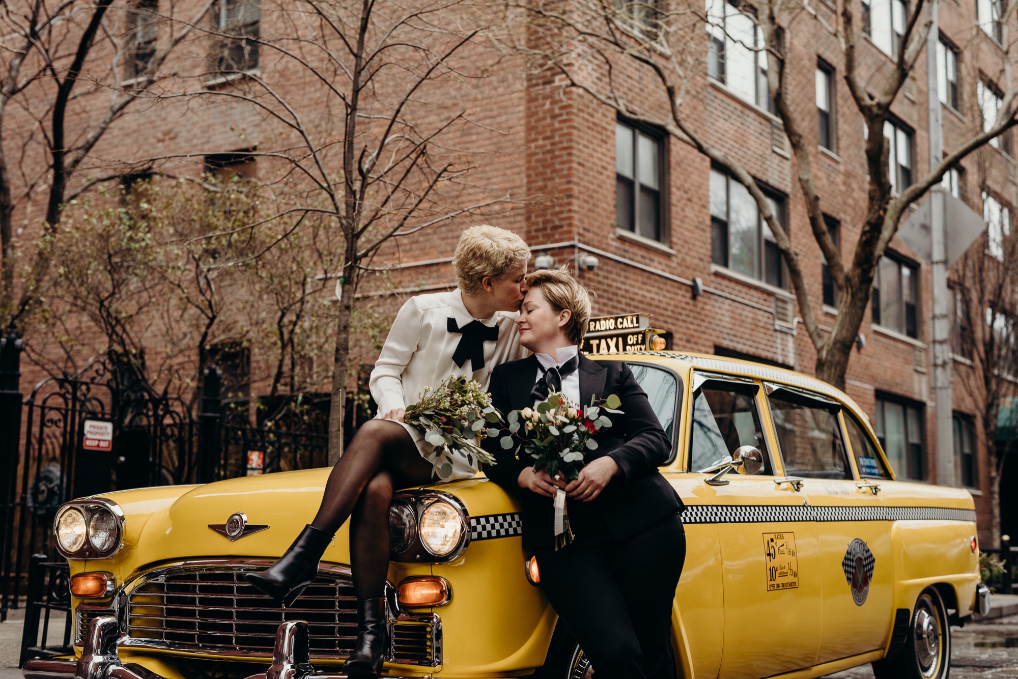 a portrait of a wedding couple in a vintage cab in new york city, new york
