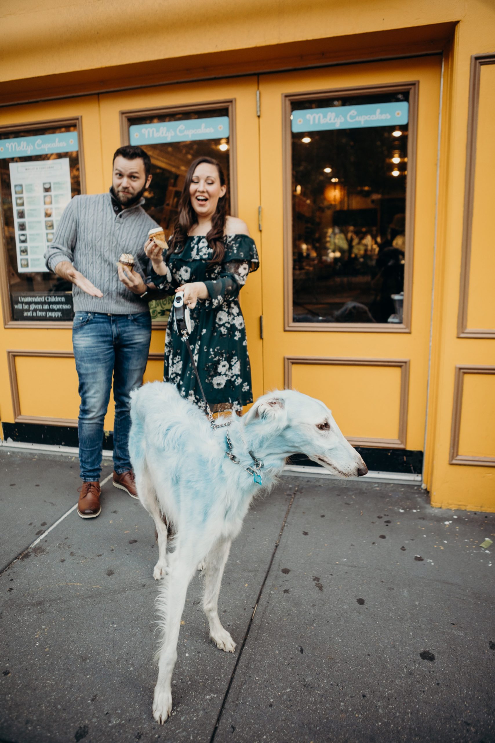 engagement photos of a couple with a dog painted blue in the west village, new york city