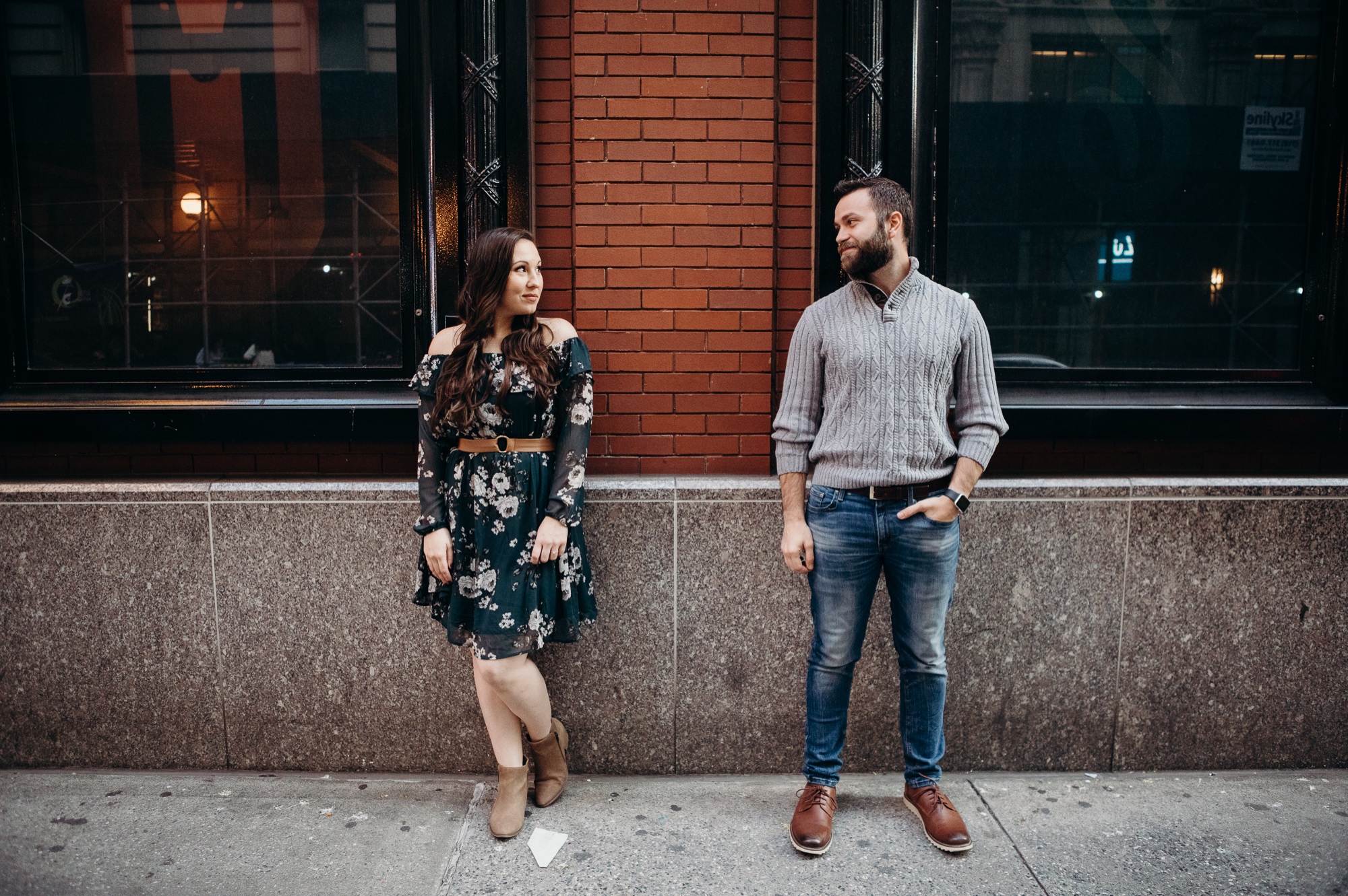 engagement photos of a couple in front of the lyric theater in times square, new york city