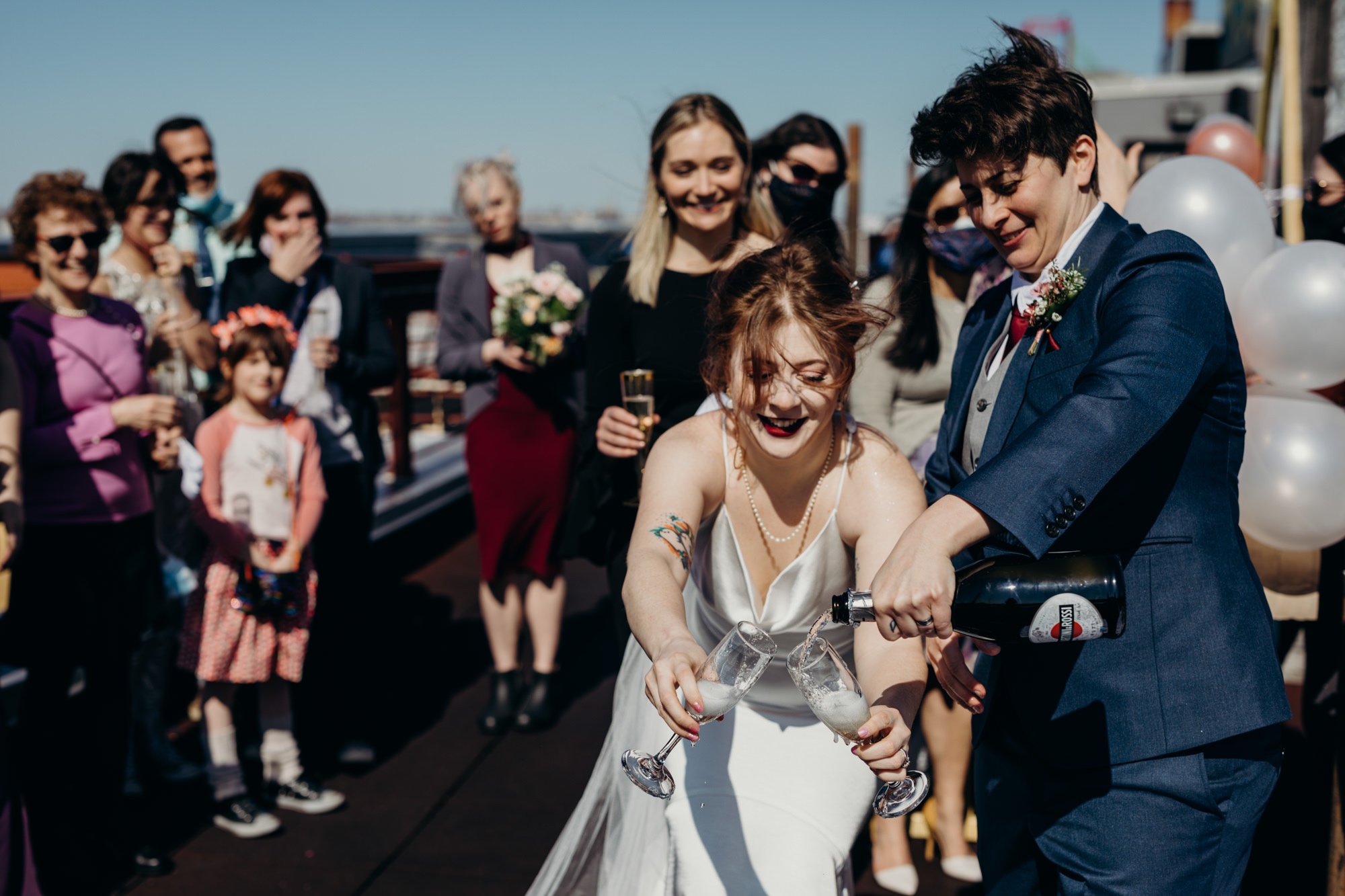 a couple toasts with champagne after their wedding in bushwick, brooklyn