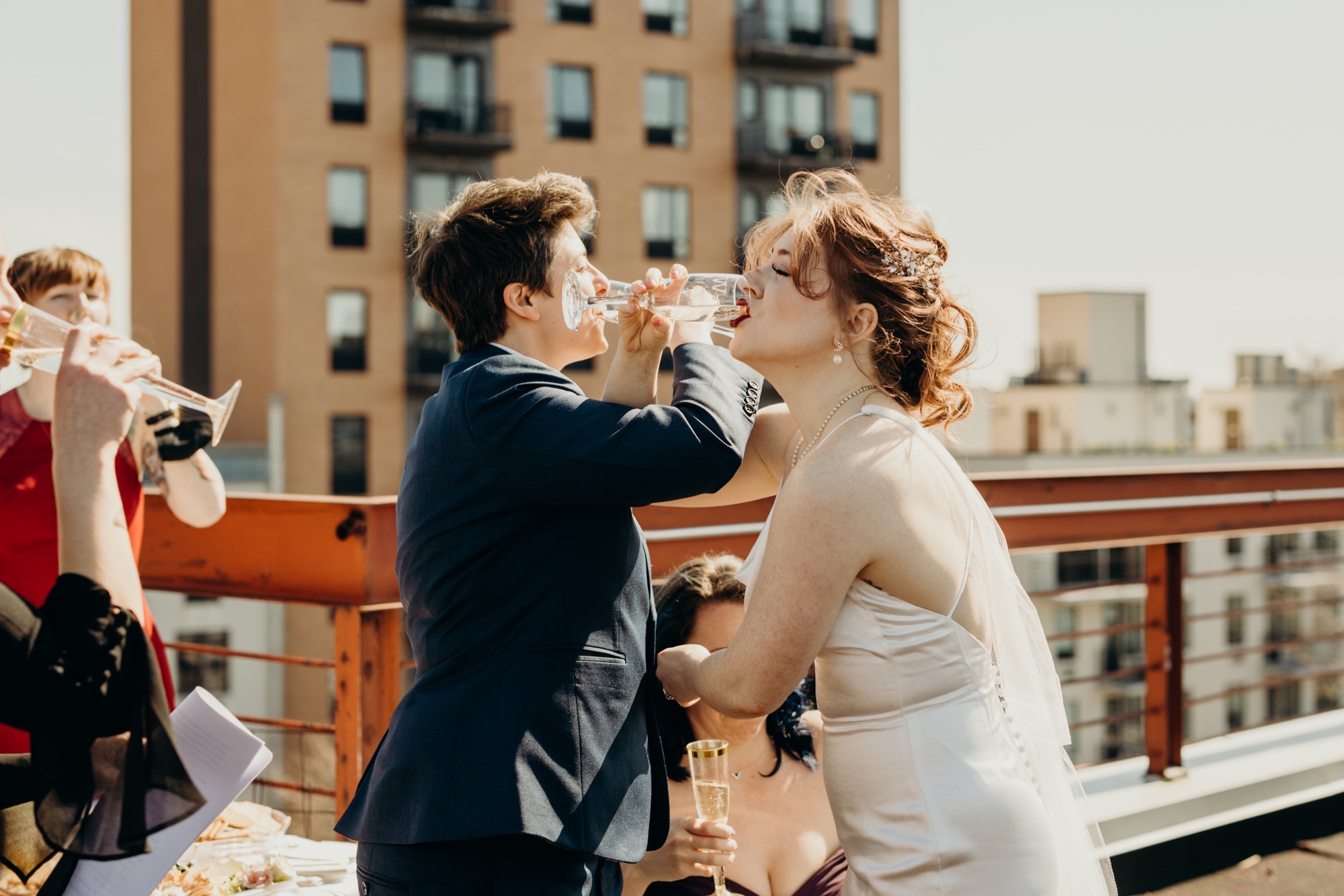 a couple toasts with champagne after their wedding in bushwick, brooklyn