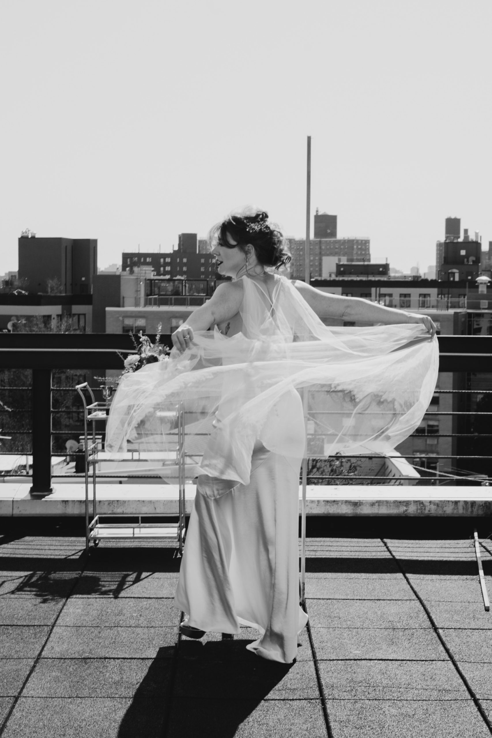 portrait of a bride playing with her veil in bushwick, brooklyn, new york city