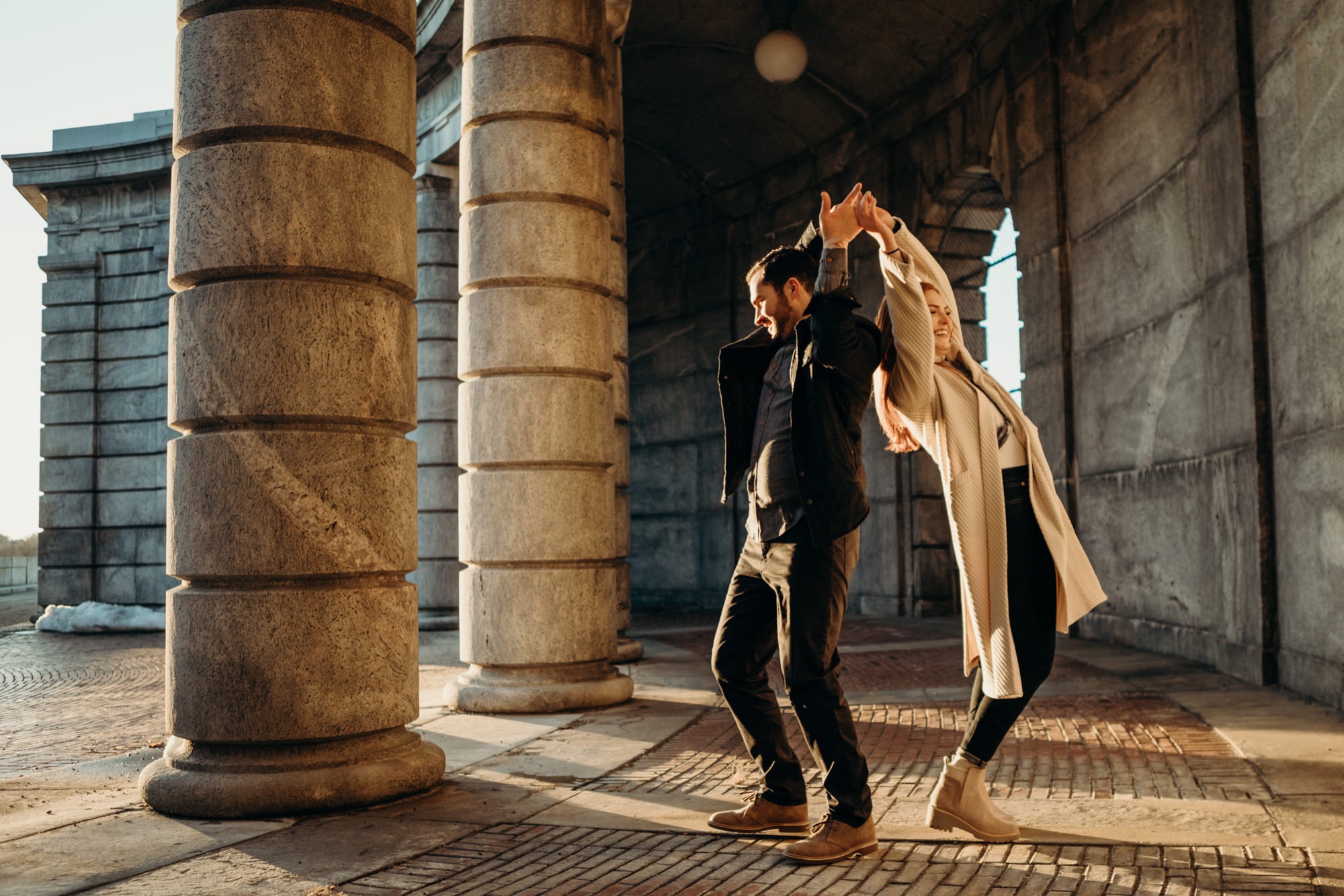a engagement portrait of a couple dancing at the kensico dam in white plains, new york