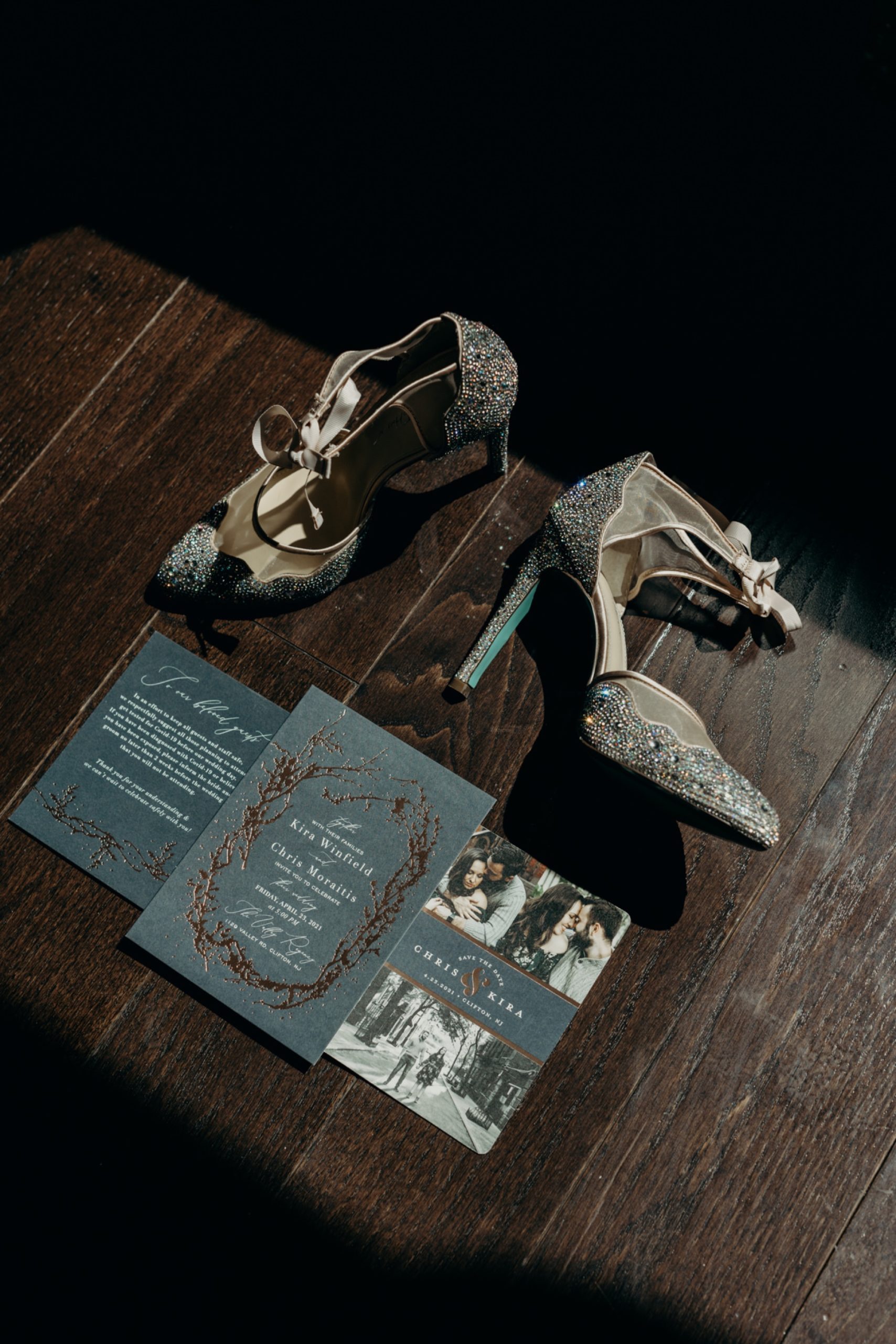photo of bridal shoes and wedding invitations on the floor