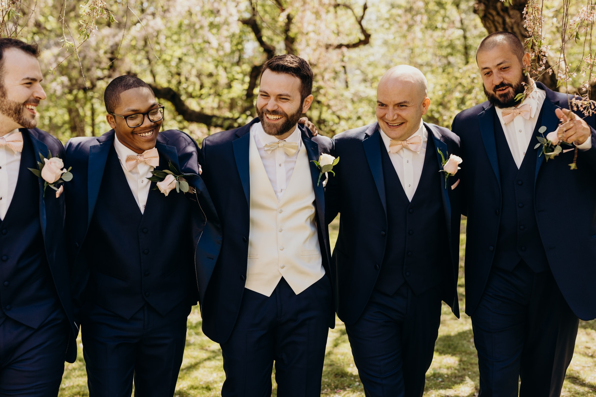 portrait of a groom and his groomsmen at a park in new jersey