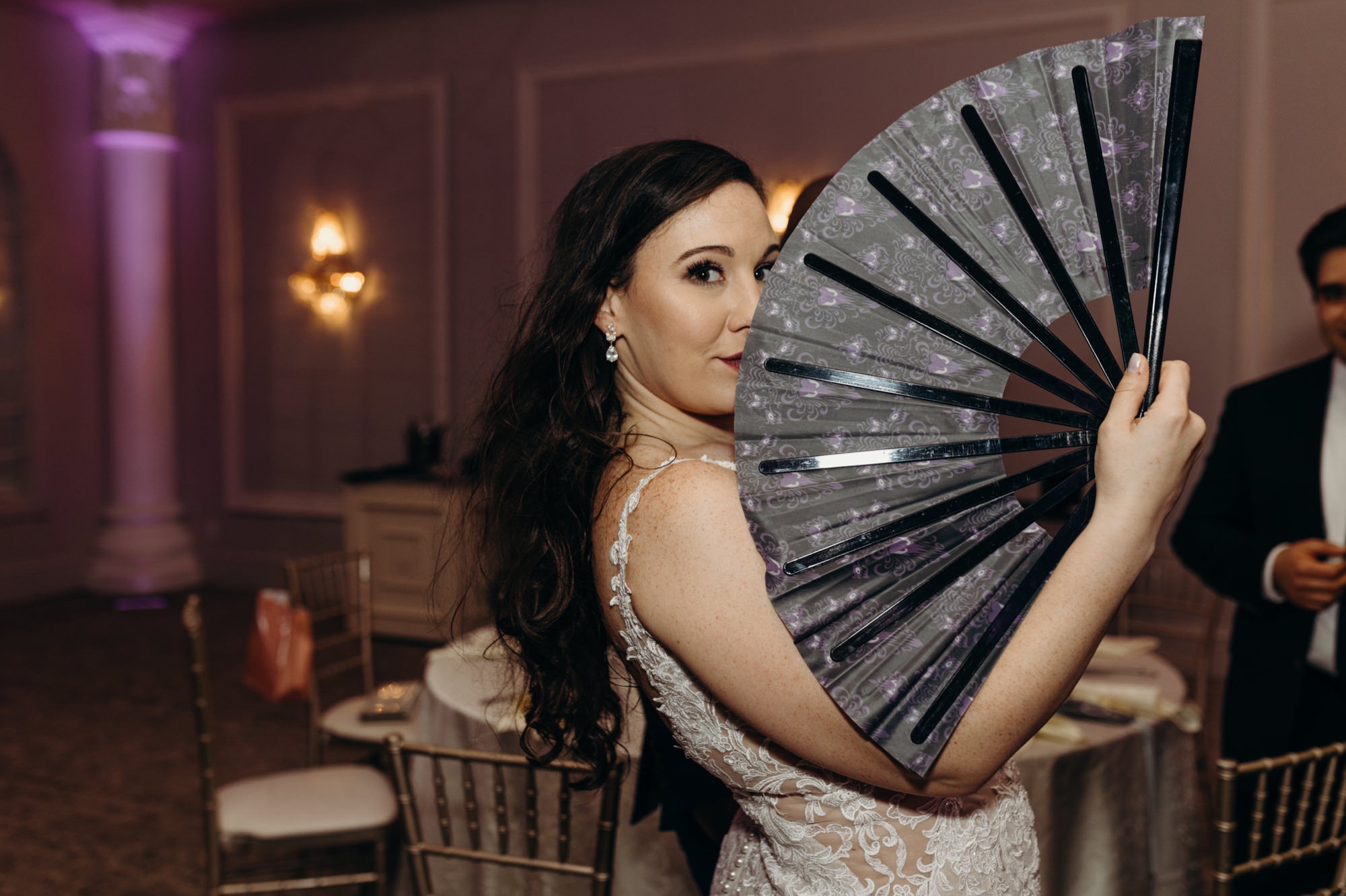 bride holding a fan during a reception at a wedding at valley regency in new jersey