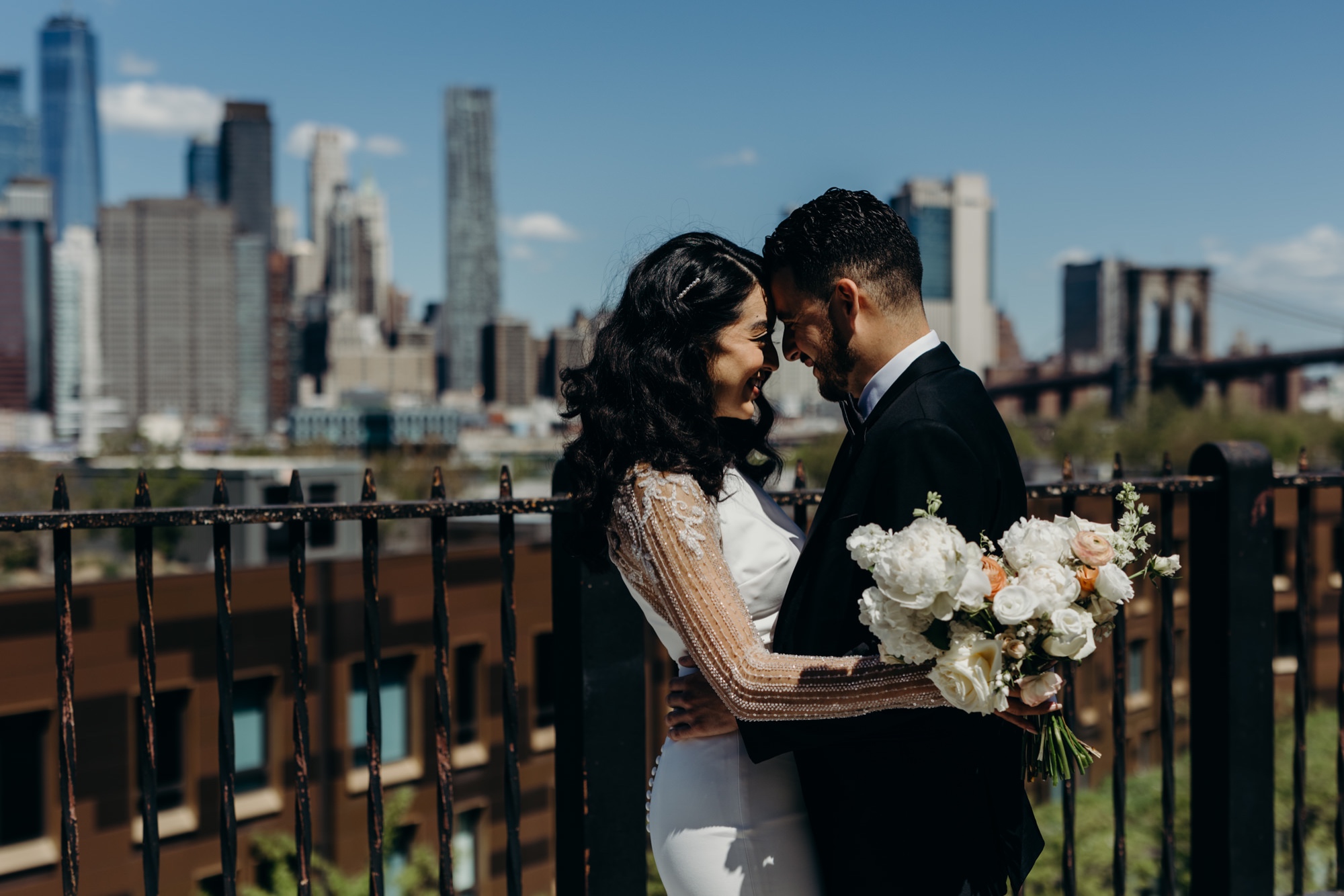 portrait of newlyweds in front of the new york city skyline
