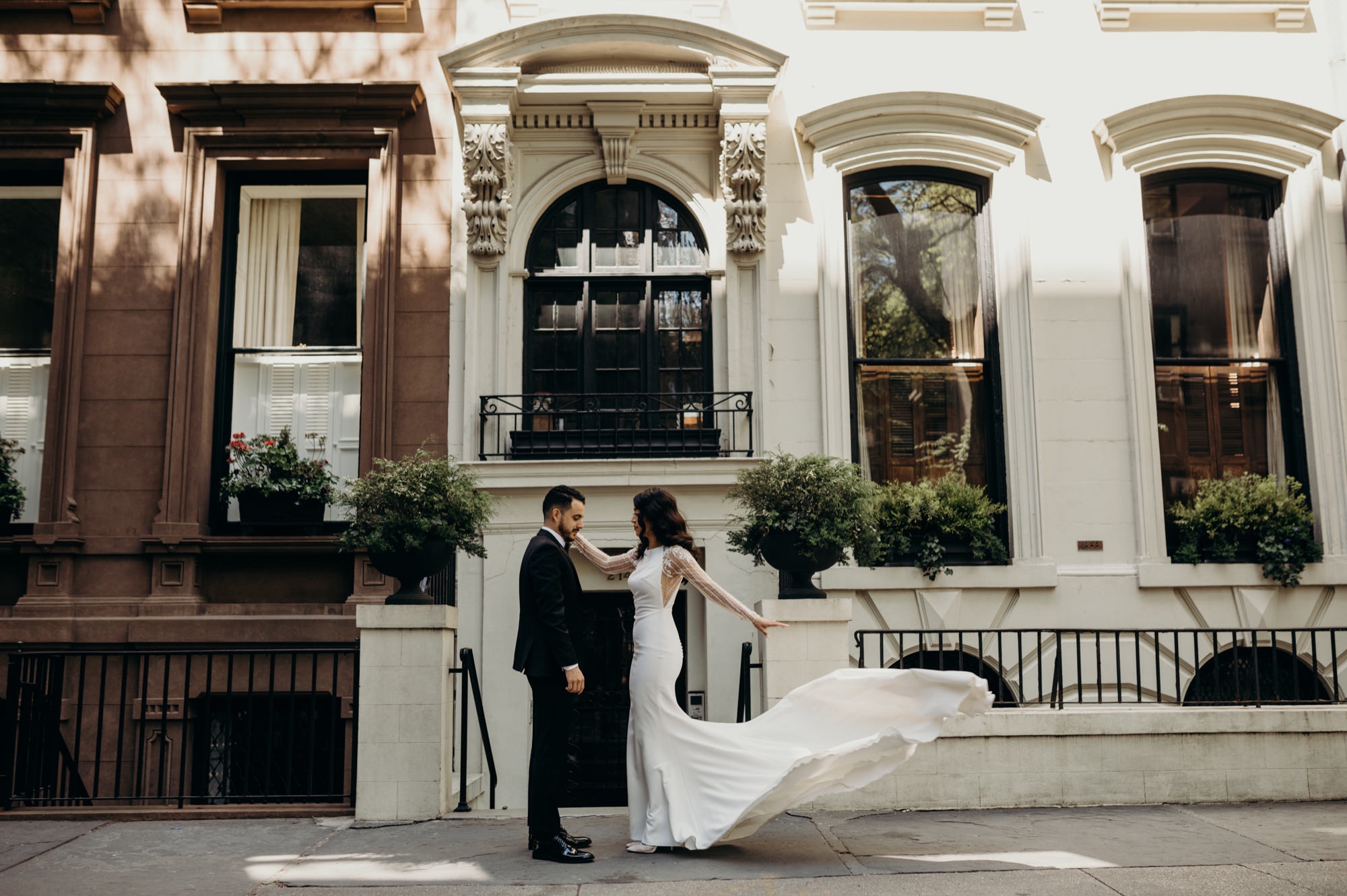 photograph of a bride and groom with wedding dress flowing in the wind in brooklyn, new york city