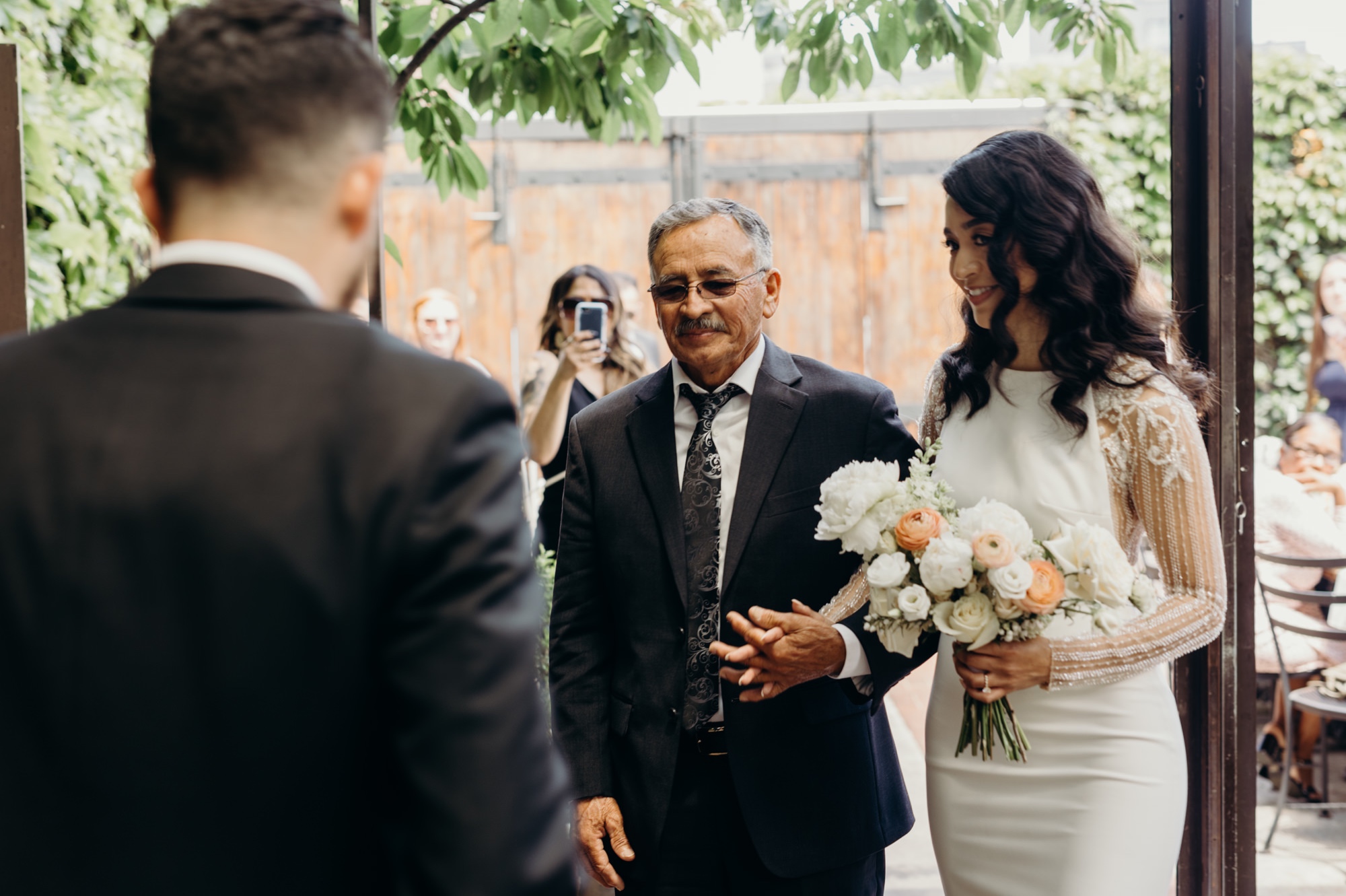 bride being handed off by her father during her wedding ceremony in aurora, brooklyn, in new york city