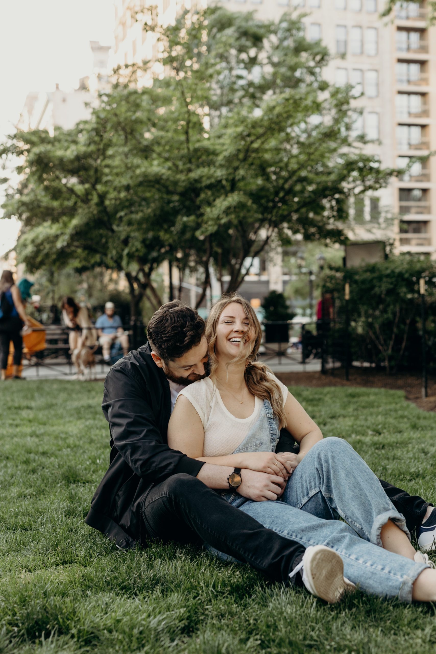 portrait of a couple sitting in union square during their engagement session in new york city