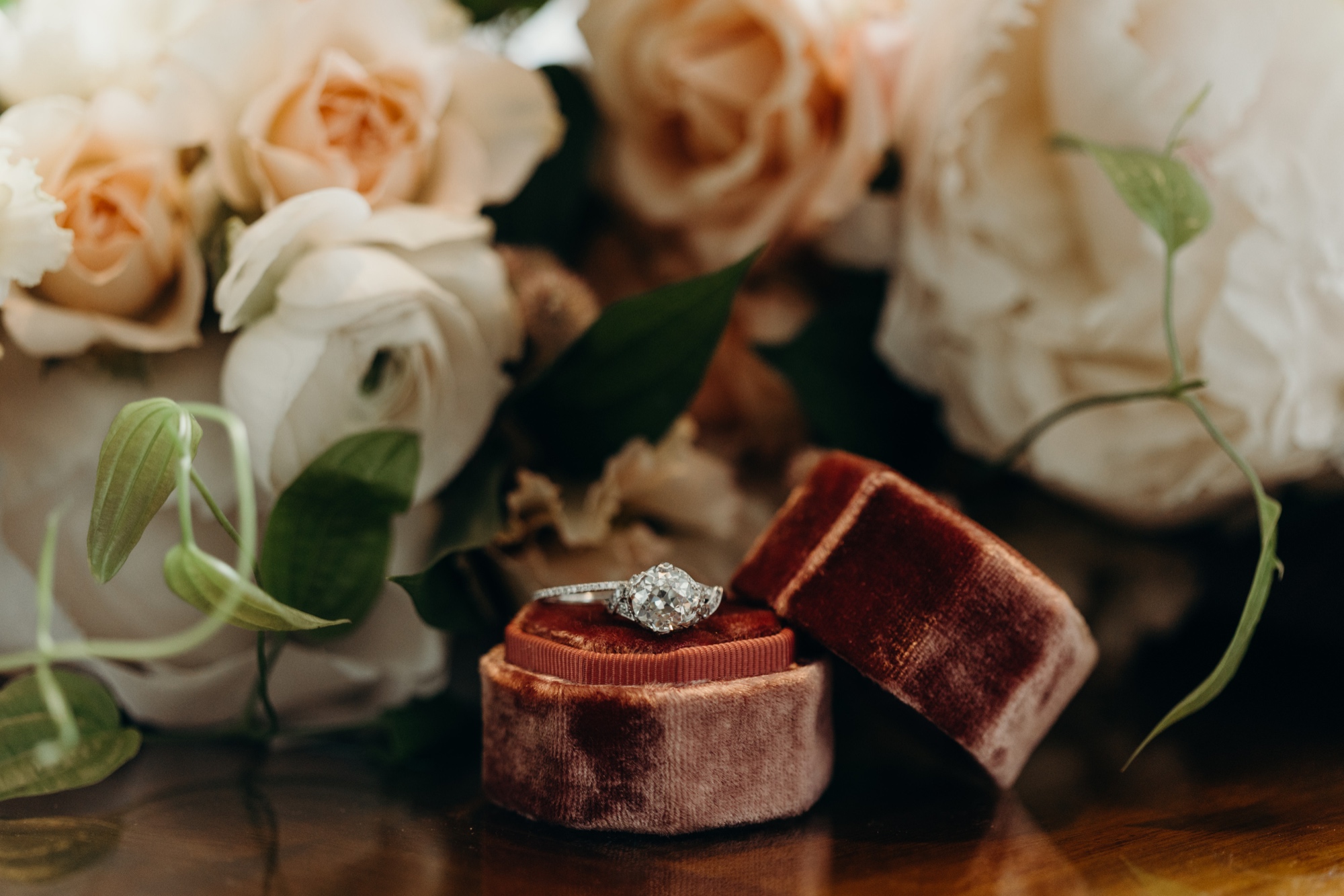 wedding rings surrounded by flowers