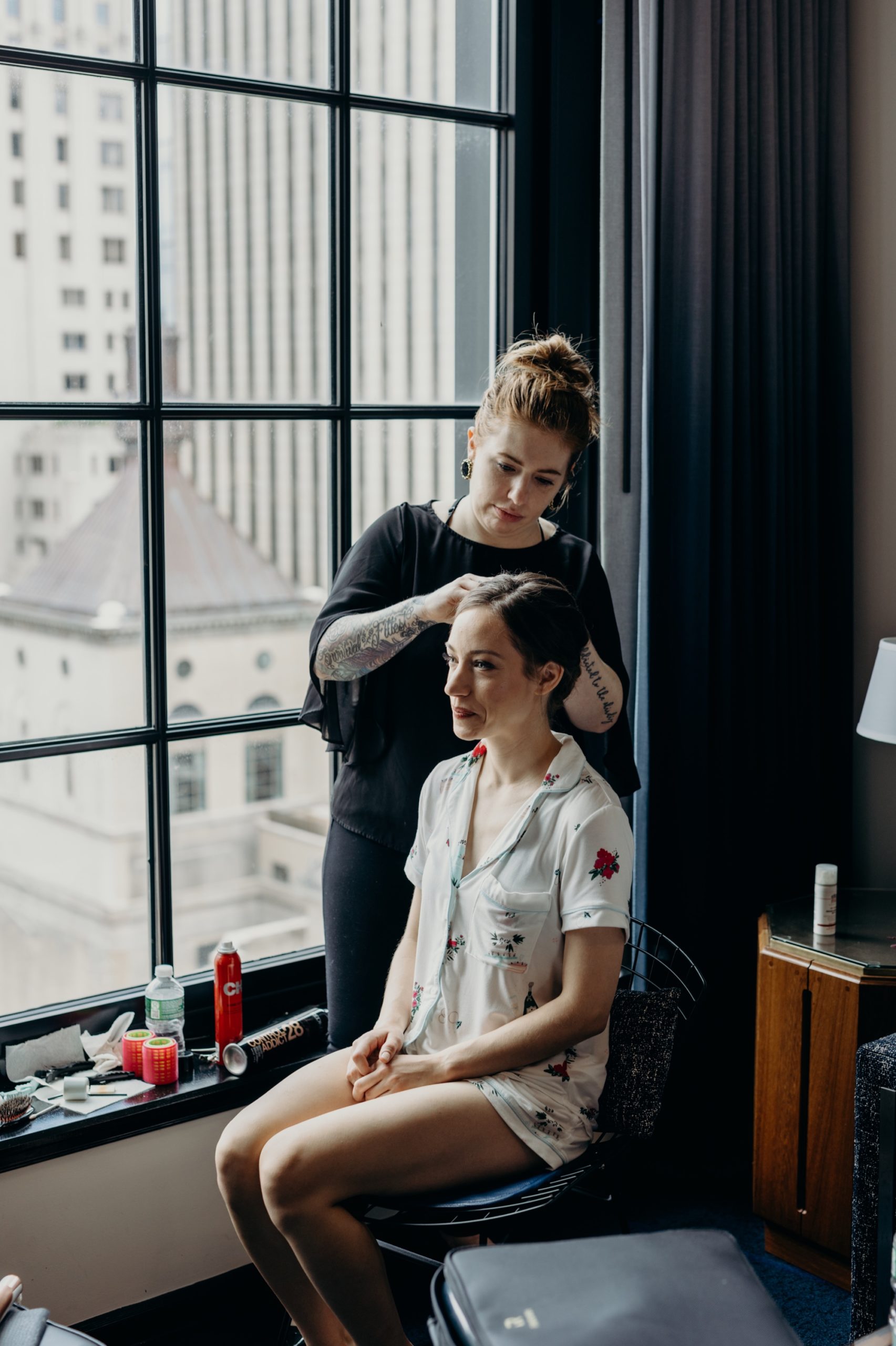 bride getting her hair done in front of a window at le parker meridien in new york city