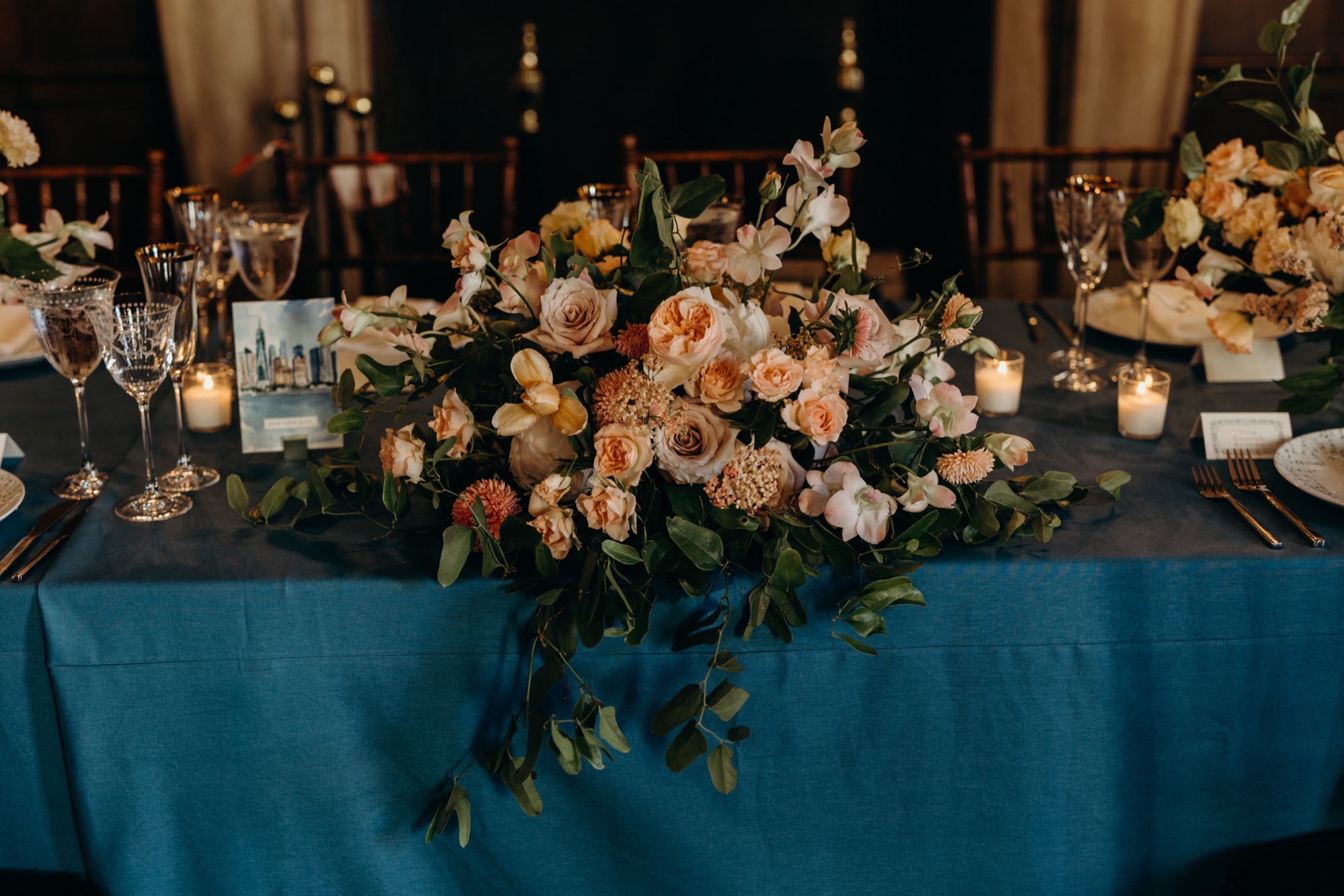 wedding reception details and head table flower arrangement at harold pratt house in new york city