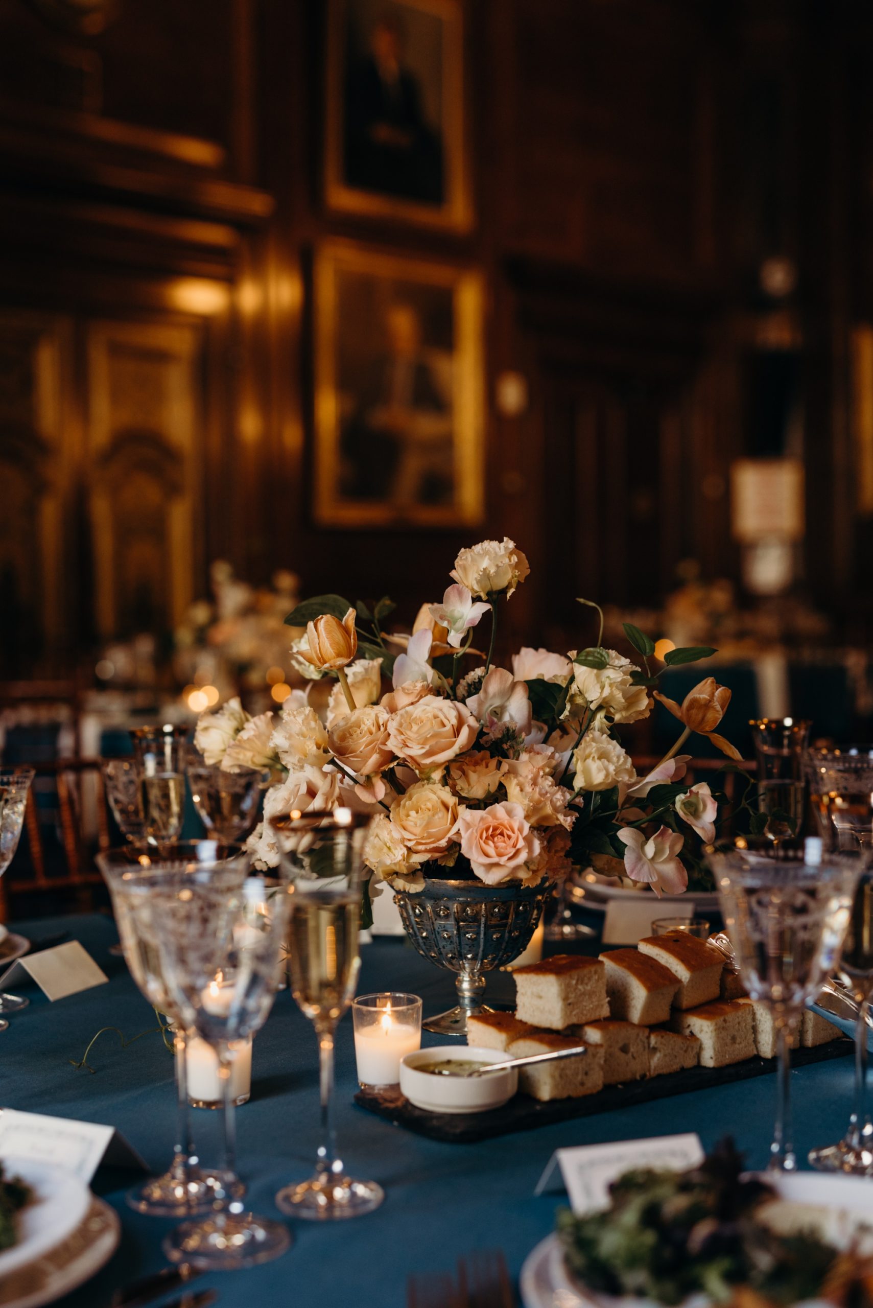 table flower arrangements during a wedding reception at harold pratt house in new york city