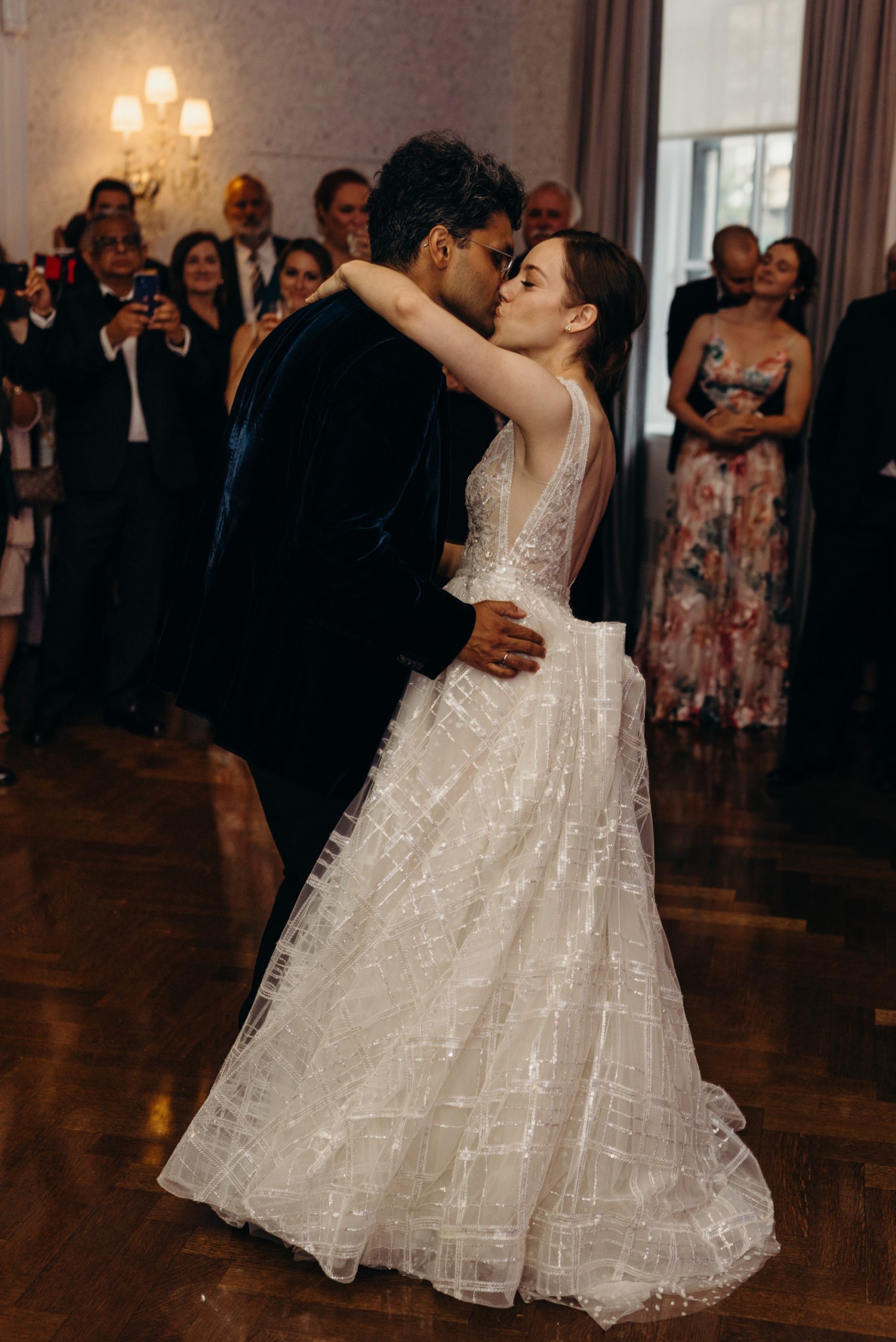 bride and groom kiss during their first dance at harold pratt house in new york city