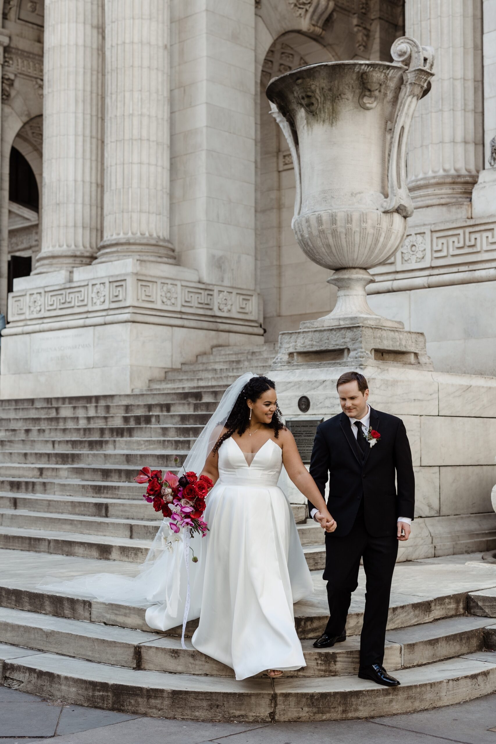 bride and groom walking down the steps at nypl