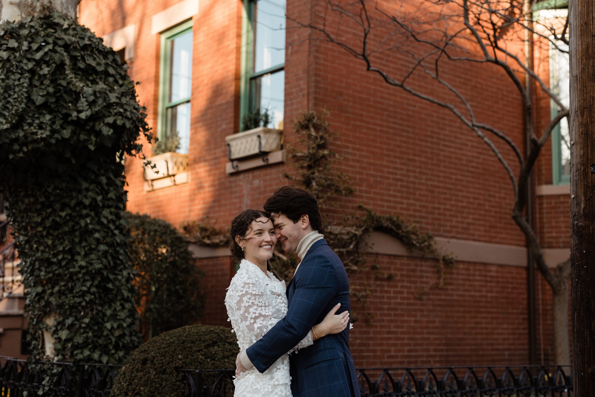 a couple hugging on the corner in hoboken, new jersey